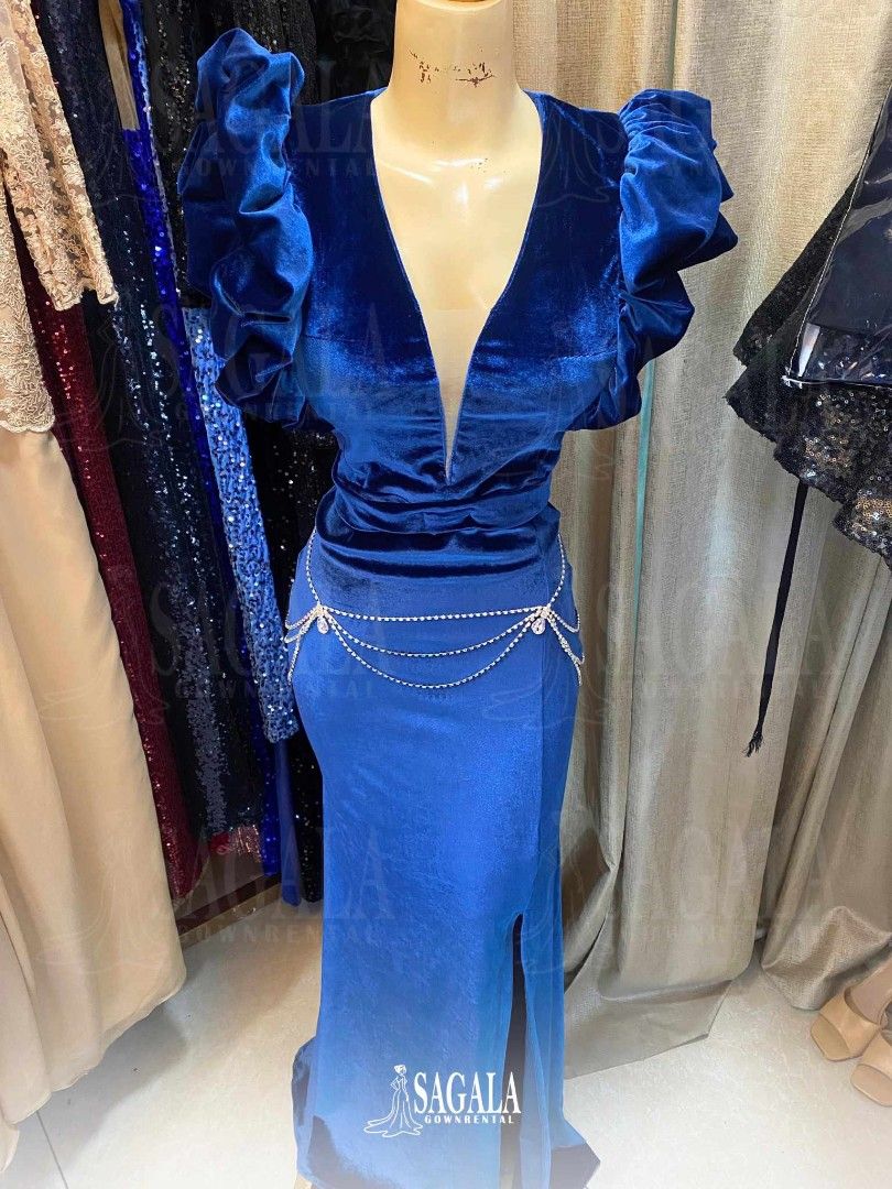 Blue Velvet Evening Gown (Category: Evening dresses & gowns) located in Dasmarinas. Submitted by sagalagown66473 (Listing ID 1438026761, Image 1). Description: - Elegant blue velvet evening gown - Plunging neckline - Puff sleeves - Fitted silhouette - Thigh-high slit - Includes delicate chain belt - Ideal for special occasions.