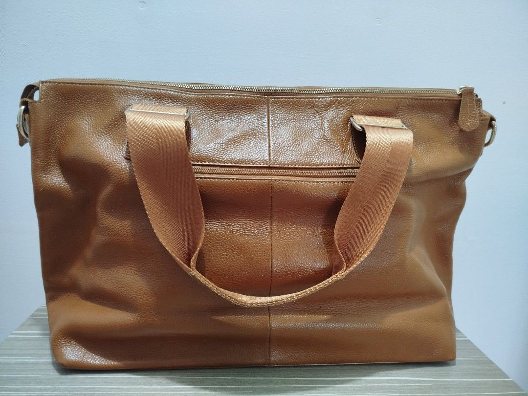 Brown Leather Large Tote/Carryall Bag (Category: Shoulder Bags) located in Cavite. Submitted by prncs.jc (Listing ID 1438001387, Image 2). Description: Product Description: - Item: Brown Leather Large Tote/Carryall Bag - Color: Tan Brown - Material: Genuine Leather - Closure: Secure top zipper closure - Handle/Strap: Durable dual canvas shoulder straps with metal hardware Interior: - Black jacquard fabric lining with logo print - One large intern