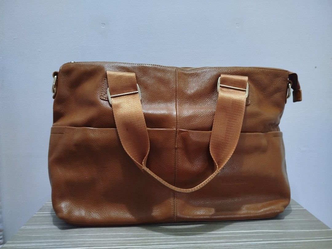Brown Leather Large Tote/Carryall Bag (Category: Shoulder Bags) located in Cavite. Submitted by prncs.jc (Listing ID 1438001387, Image 1). Description: Product Description: - Item: Brown Leather Large Tote/Carryall Bag - Color: Tan Brown - Material: Genuine Leather - Closure: Secure top zipper closure - Handle/Strap: Durable dual canvas shoulder straps with metal hardware Interior: - Black jacquard fabric lining with logo print - One large intern