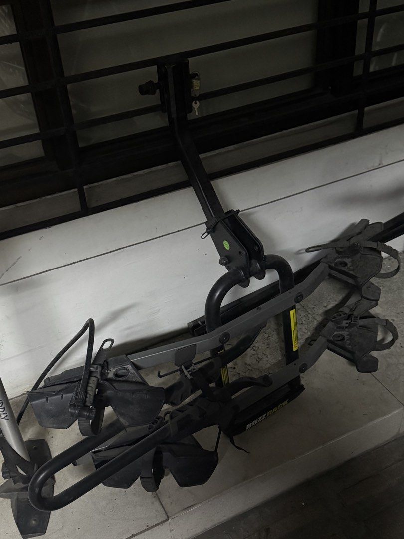 Buzz Rack Bike Rack (Category: Bicycles) located in Quezon City. Submitted by dennistim (Listing ID 1437940459, Image 1). Description: - Brand: Buzz Rack - Color: Black and Gray - Mounts on vehicle - Holds multiple bikes (2) - Includes securing straps - Features a locking mechanism for security.