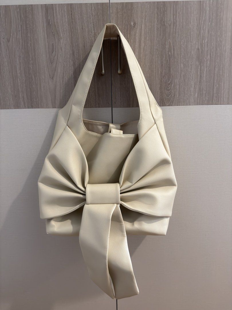 By Reese Collins Latonio Bow Bag (Category: Shoulder Bags) located in Quezon City. Submitted by ianams (Listing ID 1437979904, Image 3). Description: - Reese Collinie Latonio handbag worn by Heart E. - Cream color - Maxi size - Spacious interior - Worn once Ctto of the photos.
