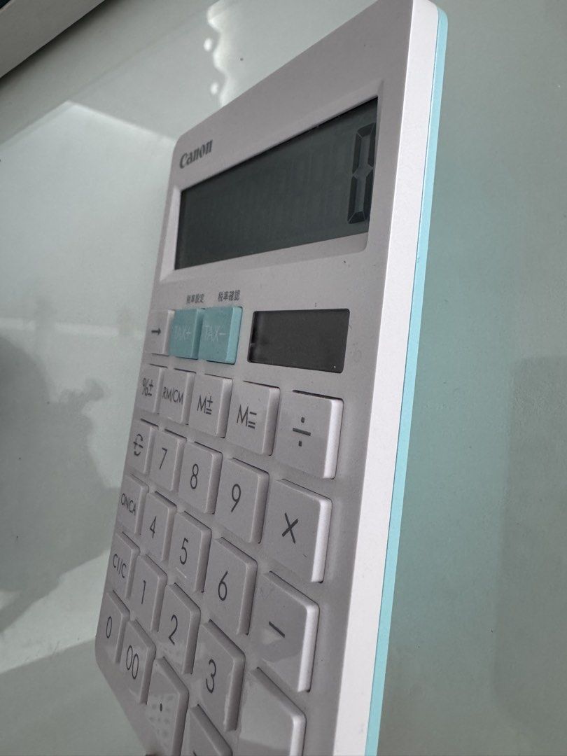 Canon HS-1200TC Calculator (Category: Office & Business Technology) located in Manila. Submitted by decluterthings888 (Listing ID 1437975875, Image 3). Description: - Canon HS-1200TC calculator - Large, easy-to-read display - Includes tax calculation buttons - Solar cell battery - Stylish white body with light blue accents - In good working condition.