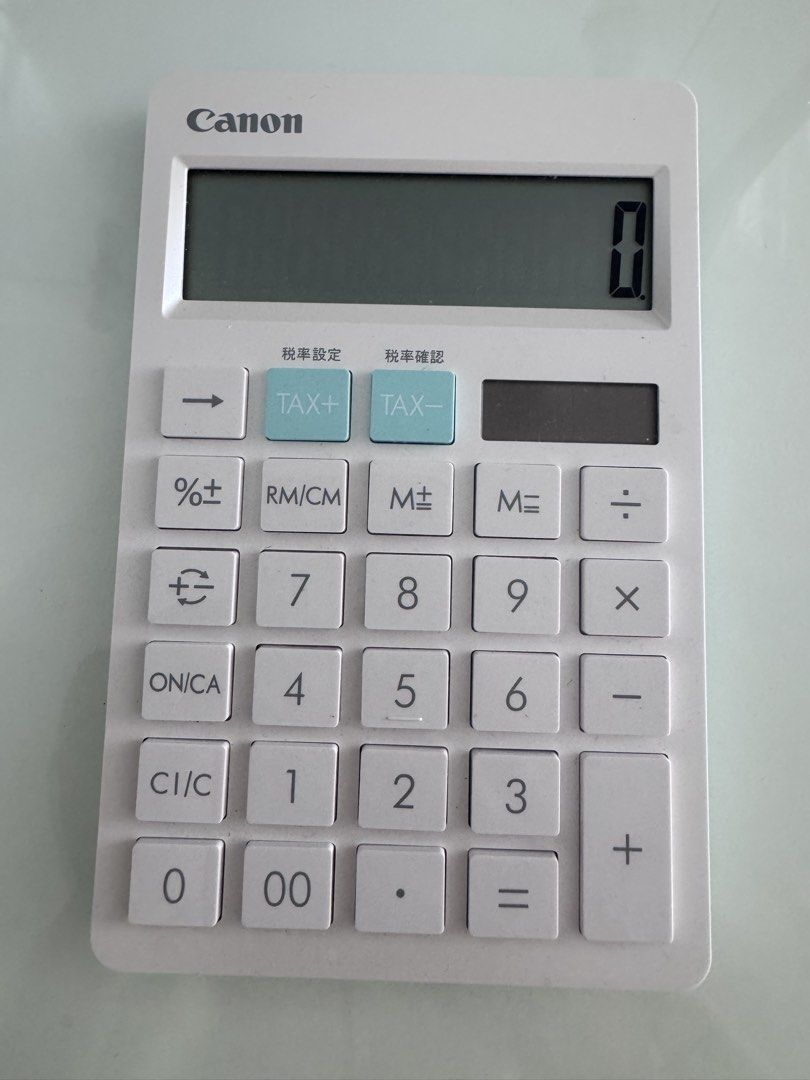 Canon HS-1200TC Calculator (Category: Office & Business Technology) located in Manila. Submitted by decluterthings888 (Listing ID 1437975875, Image 1). Description: - Canon HS-1200TC calculator - Large, easy-to-read display - Includes tax calculation buttons - Solar cell battery - Stylish white body with light blue accents - In good working condition.