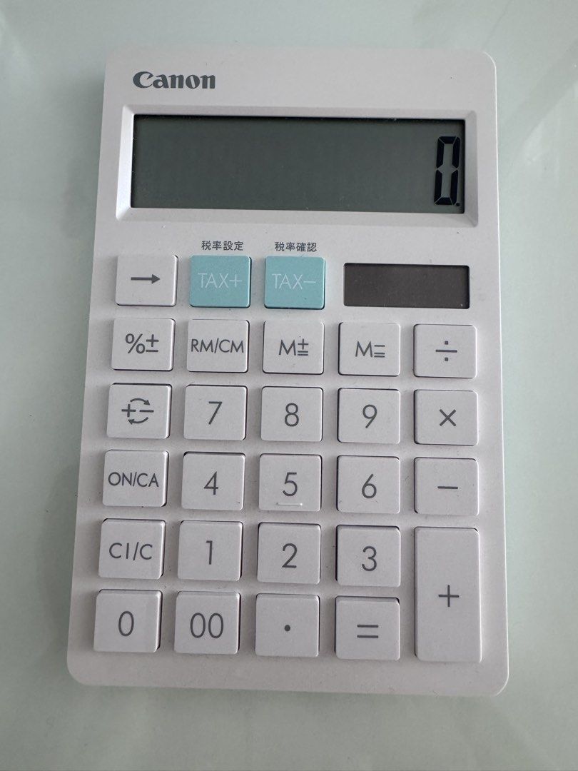 Canon HS-1200TC Calculator (Category: Office & Business Technology) located in Manila. Submitted by decluterthings888 (Listing ID 1437975875, Image 2). Description: - Canon HS-1200TC calculator - Large, easy-to-read display - Includes tax calculation buttons - Solar cell battery - Stylish white body with light blue accents - In good working condition.