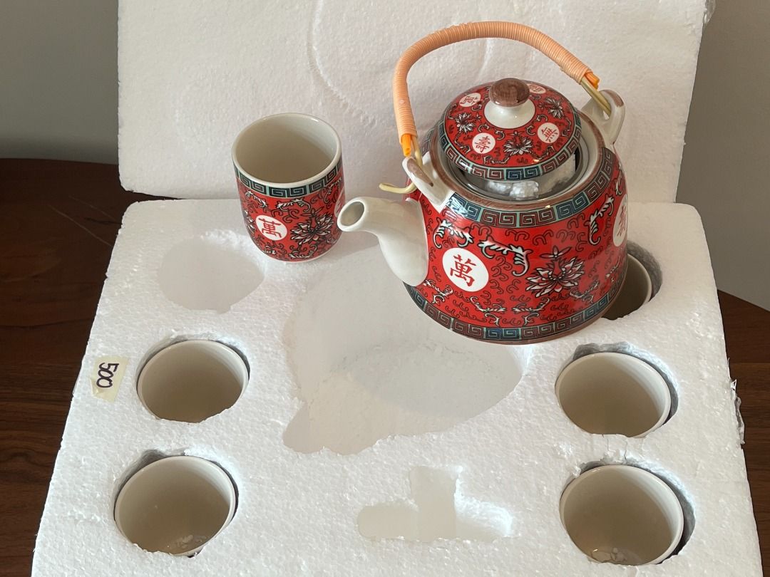 Chinese Porcelain Tea Set with bamboo handle (Category: Coffee & Tea Tableware) located in Manila. Submitted by ncaluban (Listing ID 1437967489, Image 1). Description: Chinese Porcelain Tea Set with bamboo handle Never used 1 teapot 6 cups Tomas Morato area pickup Delivery c/o buyer - Stunning Chinese tea set - Features a teapot and multiple cups - Elegant red and white color scheme - Intricate floral and Chinese character designs - Teapot with w