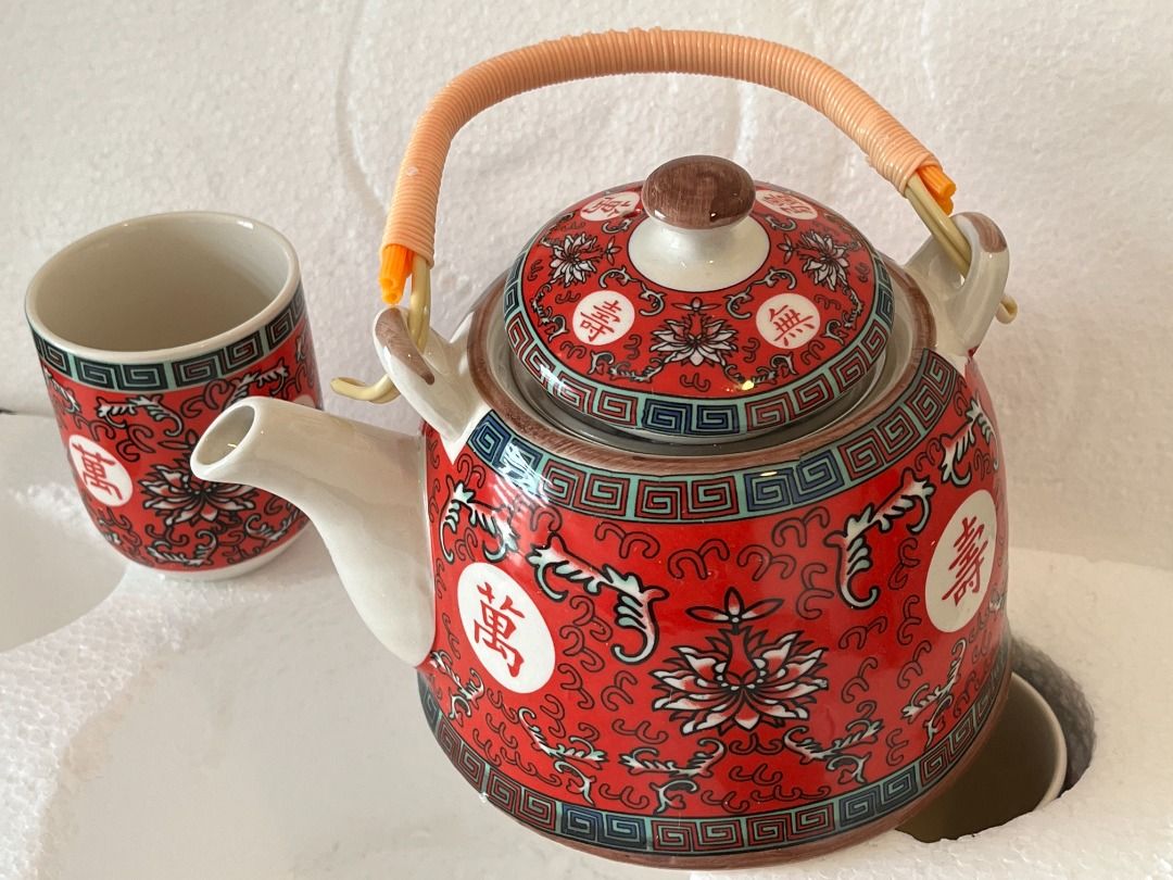 Chinese Porcelain Tea Set with bamboo handle (Category: Coffee & Tea Tableware) located in Manila. Submitted by ncaluban (Listing ID 1437967489, Image 2). Description: Chinese Porcelain Tea Set with bamboo handle Never used 1 teapot 6 cups Tomas Morato area pickup Delivery c/o buyer - Stunning Chinese tea set - Features a teapot and multiple cups - Elegant red and white color scheme - Intricate floral and Chinese character designs - Teapot with w