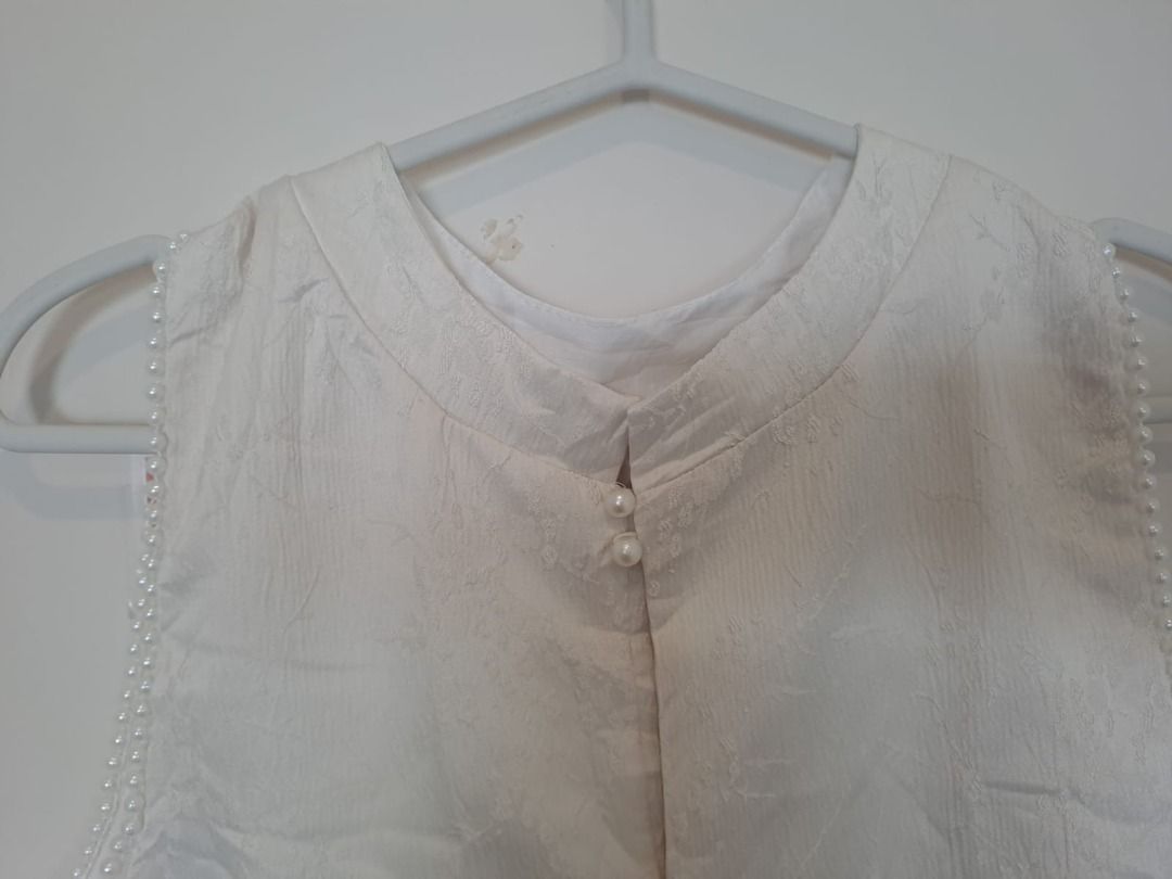 CHINISE TOP WITH PEARL DESIGN (Category: Blouses) located in Mandaluyong City. Submitted by epicowl-c93c (Listing ID 1437981662, Image 2). Description: The highlighted item is a white mandarin collar sleeveless top featuring a textured jacquard/brocade fabric pattern, delicate faux-pearl back closure button accents, and pearled trim lining the armholes. This elegant aesthetic leans heavily into modern East Asian fashion aesthetics, resembling a c