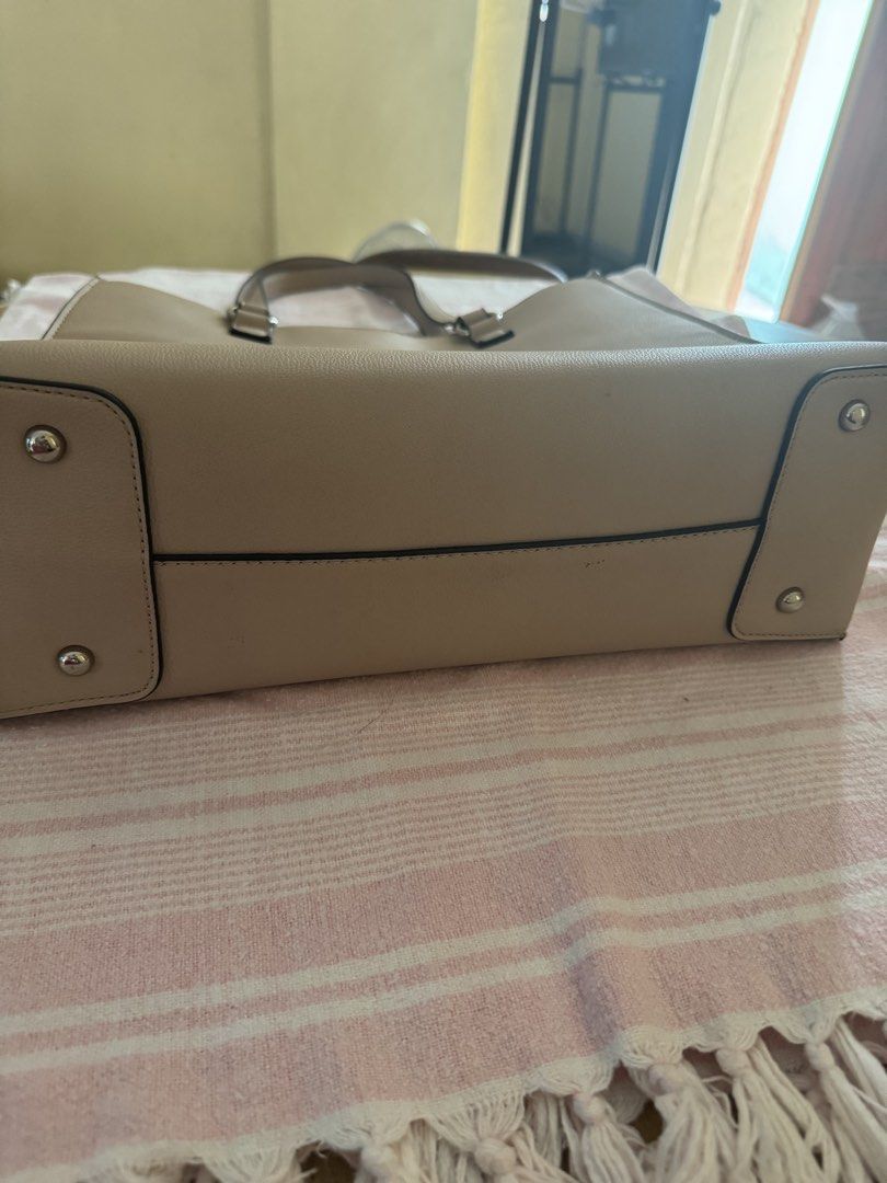 Mathew and Julian Tote Bag (Category: Luxury Bags & Wallets) located in Pasig City. Submitted by mary.mary7 (Listing ID 1437981490, Image 3). Description: - Beige Mathew and Julian tote bag - Double handles - Rectangular shape - Small logo - Zipper closure - Multiple interior compartments - Metal feet on the bottom - Dark grey interior lining Size Length: 13.5 inches Height: 10.5 inches Thickness: 5 inches Purchased from USA Shipment/Pick-up c/o 