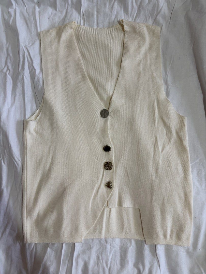 Cream-colored Button-up Vest (Category: Vests) located in Manila. Submitted by andreacap (Listing ID 1437965500, Image 1). Description: - Cream-colored knit vest - V-neckline - Decorative buttons: silver, black, rose-shaped, and heart-shaped - Sleeveless design - Slightly asymmetrical hemline 🎀 currently decluttering/selling pre-loved clothes, check my page for more details! 🎀 please manage expectations, you may send me a dm for more photos 🎀 