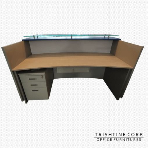 Curved Reception Desk with Glass Top (Category: Office Furniture & Fixtures) located in Caloocan City. Submitted by trishtine_jim9 (Listing ID 1437959604, Image 2). Description: - Elegant curved reception desk - Features a glass top - Stylish white, blue, and wood-tone finish - Includes a built-in drawer - Small cabinet with three drawers - Designed for office use - Branded "Trishtine Corp. Office Furnitures" DISCLAIMER: Price is for Posting Purp