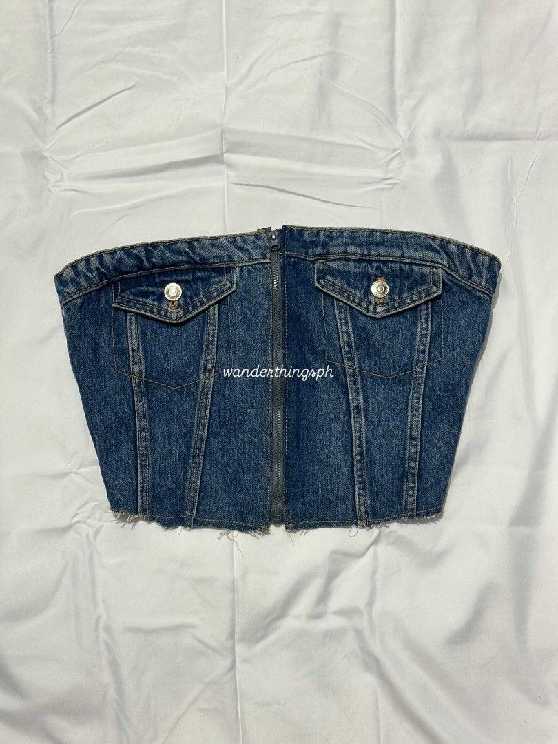 Denim Corset Top (Category: Sleeveless) located in Malabon City. Submitted by WanderThingsPH (Listing ID 1438082638, Image 1). Description: - Denim corset top - Front zipper closure - Two front pockets with button details - Shirred back panel for comfort - Raw hemline - Perfect for a casual and chic look.