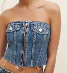 Denim Corset Top (Category: Sleeveless) located in Malabon City. Submitted by WanderThingsPH (Listing ID 1438082638, Image 2). Description: - Denim corset top - Front zipper closure - Two front pockets with button details - Shirred back panel for comfort - Raw hemline - Perfect for a casual and chic look.