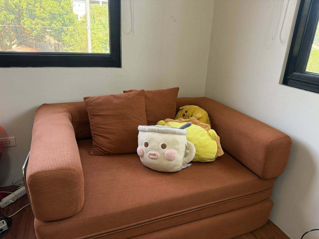 Dreame Modern Simple Full Sponge Sofa Bed (Category: Sofas) located in Manila. Submitted by ecallierju53820 (Listing ID 1438035293, Image 1). Description: - Orange corduroy sofa bed - Converts into a bed - Includes two matching pillows - Features a corduroy texture - Minor stain present - Original price: ₱21,999.00.