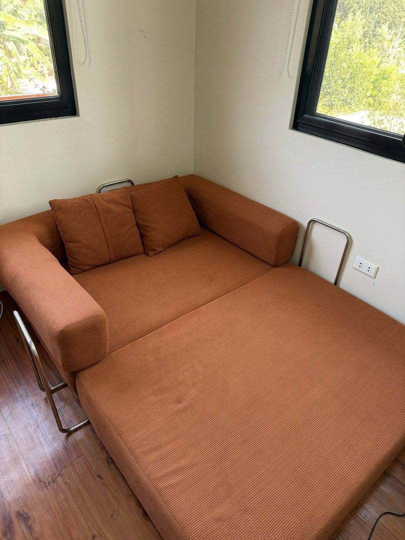 Dreame Modern Simple Full Sponge Sofa Bed (Category: Sofas) located in Manila. Submitted by ecallierju53820 (Listing ID 1438035293, Image 2). Description: - Orange corduroy sofa bed - Converts into a bed - Includes two matching pillows - Features a corduroy texture - Minor stain present - Original price: ₱21,999.00.