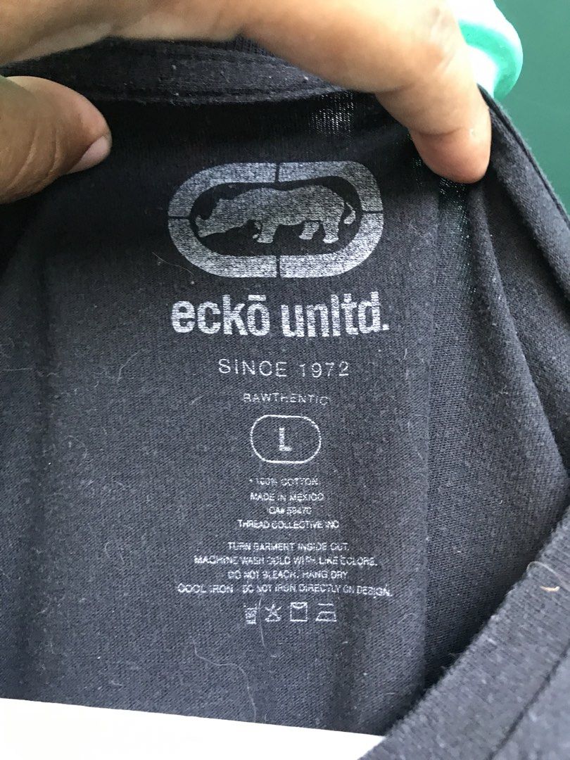 Ecko Big Logo (Category: Tshirts & Polo Shirts ) located in Manila. Submitted by zerimar01 (Listing ID 1438074604, Image 3). Description: Brand: ecko Unltd. Size: Large Measurements: 22” (Chest) × 30” (Length) Color: Black Design: Big bold “ECKO” logo on front, gradient blue/white/purple/pink, small rhino logo detail Fabric: Soft cotton Condition: Good used condition – no holes, no tears, print still clear and bright Style: Casual / Streetwear.