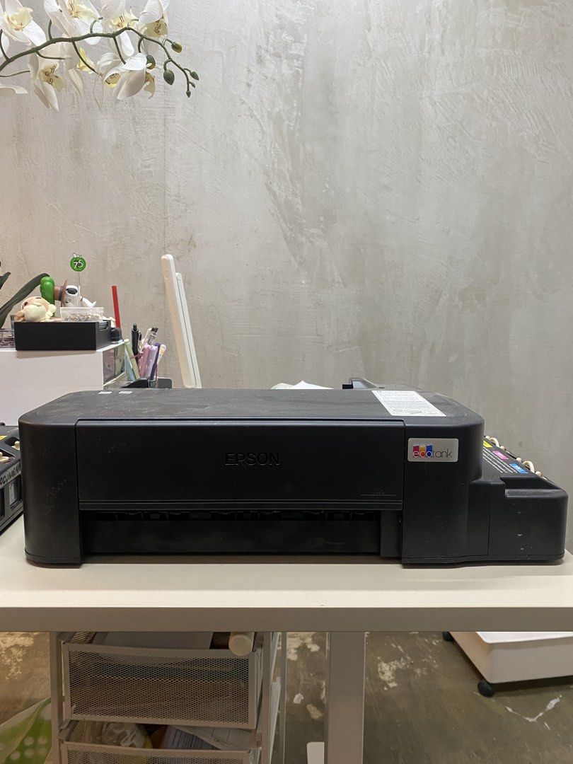 Epson L121 EcoTank Printer (2nd hand) (Category: Printers, Scanners & Copiers) located in Makati City. Submitted by july_ps28 (Listing ID 1438043886, Image 2). Description: Epson L121 EcoTank Printer – ₱1,000 for both 🖨️ ✔️ Original Epson EcoTank Printer ✔️ Powers on and working ✔️ Great for repair, parts, or DIY cleaning ✔️ 2 units available Issue: Ink flow and print output need cleaning/fixing, but units still have potential and usable parts. 