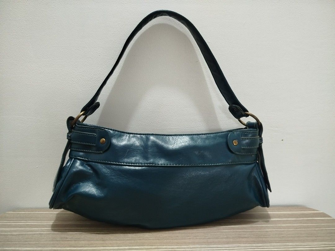 F&F Ruched Leather Shoulder Bag (Category: Shoulder Bags) located in Cavite. Submitted by prncs.jc (Listing ID 1437999256, Image 2). Description: Product Description: - Item: F&F Ruched Leather Shoulder Bag - Color: Deep Teal / Petrol Blue - Material: Genuine Leather - Closure: Top zipper closure - Handle/Strap: Single flat leather shoulder strap with antique brass-tone rings Interior: - Dark teal fabric lining - One main compartment with an inte