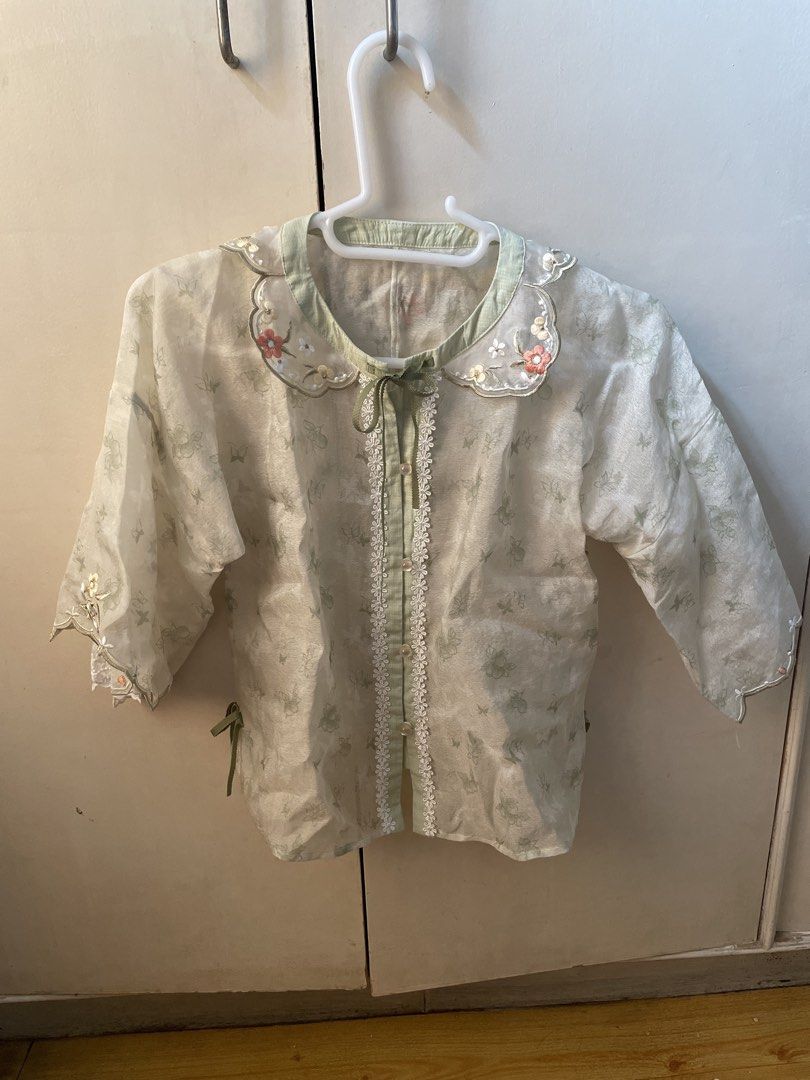 Floral Embroidered Fairy Blouse (Category: Blouses) located in Paranaque City. Submitted by commandercinnabutt (Listing ID 1437980135, Image 1). Description: - Delicate floral print blouse - Peter Pan collar with ribbon tie - Lace detailing on front - Three-quarter sleeves with scalloped edges - Light green and white color scheme.