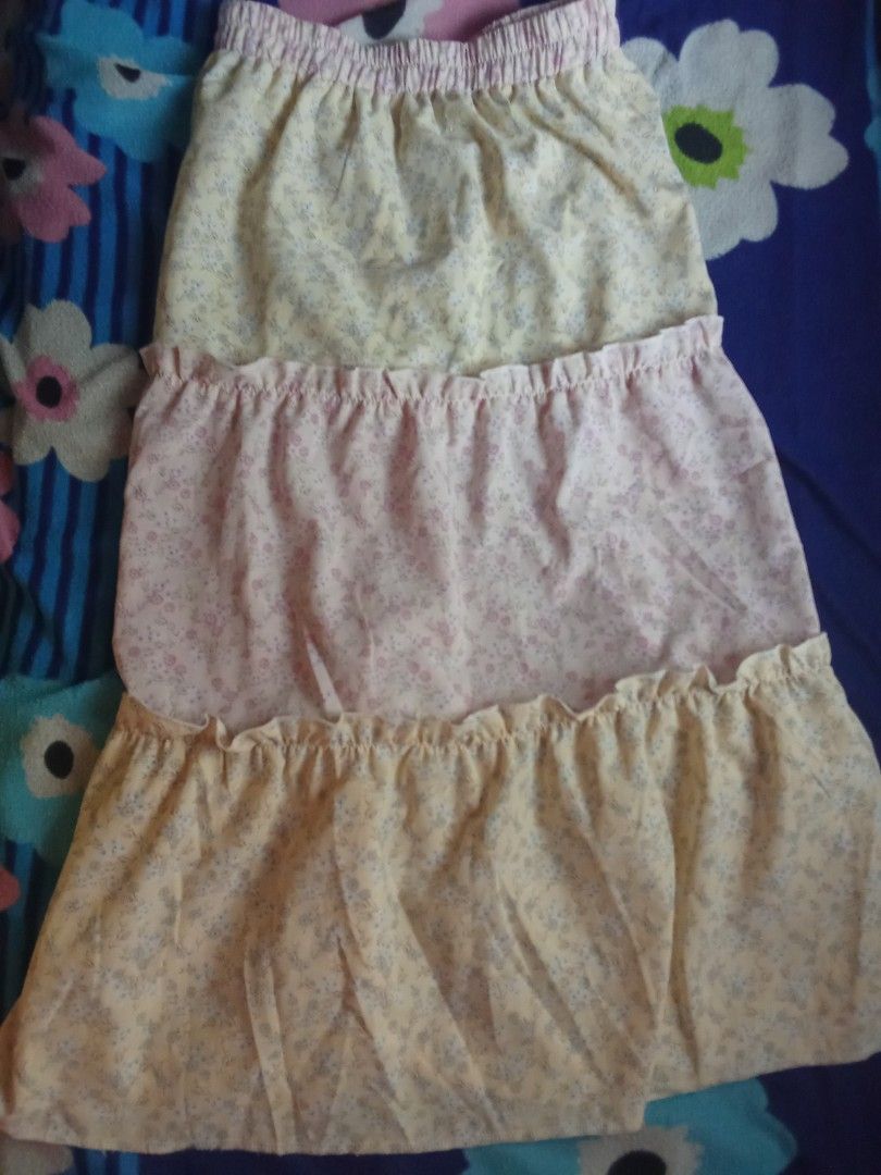 Floral Tiered Skirt (Category: Skirts) located in Bugallon. Submitted by sierra_thrifts (Listing ID 1437966377, Image 1). Description: - Floral tiered design - Comfortable elastic waistband - Lightweight fabric - Ruffled hem detail - Yellow and pink color combination.