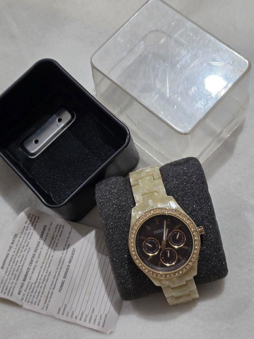 Fossil Watch with Gold Accents (Category: Women's Watches) located in Bocaue. Submitted by wendy.plew (Listing ID 1438053068, Image 1). Description: - Fossil stella watch with gold-toned bezel and gold mother of pearl bracelet. -with crystal works - Dark watch face with three sub-dials - Includes original box - Comes with a clear protective case - Includes paper (see photo ) - Stainless steel back - Fossil logo clasp - minsan lang nagamit very se