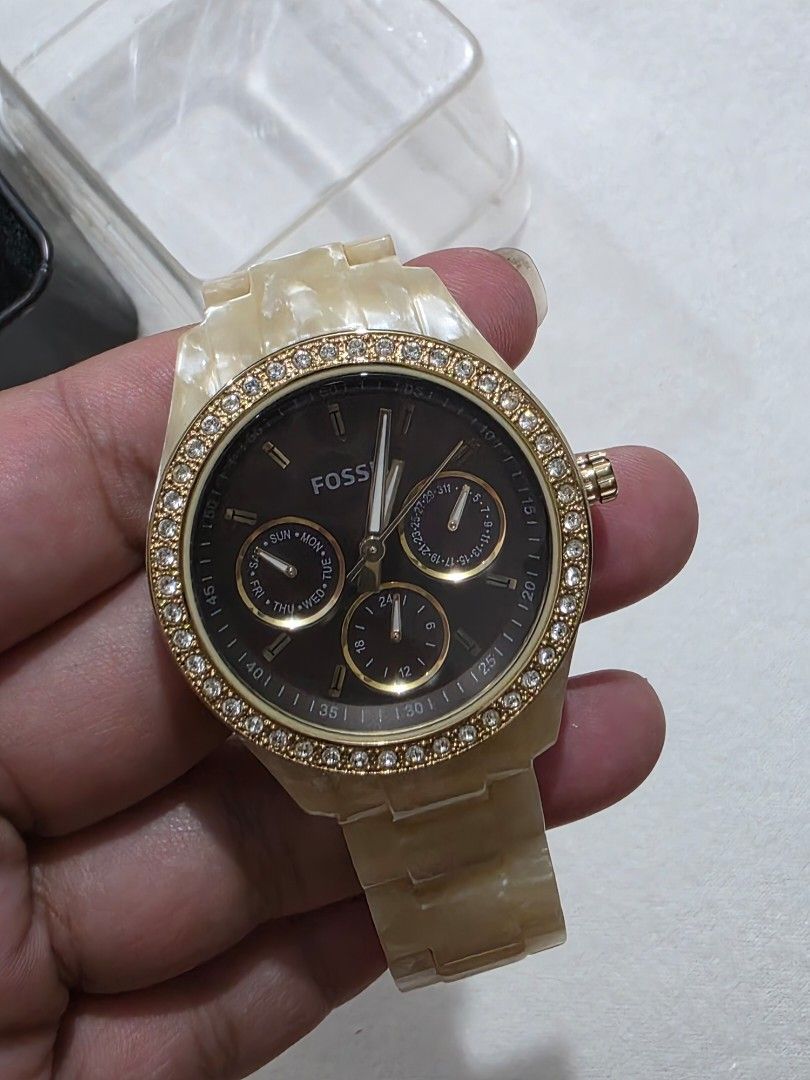 Fossil Watch with Gold Accents (Category: Women's Watches) located in Bocaue. Submitted by wendy.plew (Listing ID 1438053068, Image 3). Description: - Fossil stella watch with gold-toned bezel and gold mother of pearl bracelet. -with crystal works - Dark watch face with three sub-dials - Includes original box - Comes with a clear protective case - Includes paper (see photo ) - Stainless steel back - Fossil logo clasp - minsan lang nagamit very se