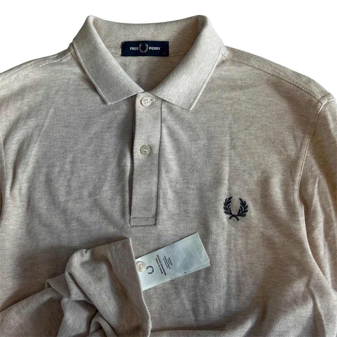 Fred Perry Long Sleeve Polo Shirt (Category: Tshirts & Polo Shirts ) located in Quezon. Submitted by webtothecloset (Listing ID 1437965972, Image 2). Description: - Fred Perry long sleeve polo shirt - Classic design - Collared neckline - Three-button placket - Solid color - Features the iconic Fred Perry laurel wreath logo - Brand new condition.