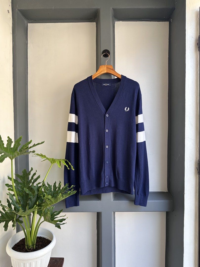Fred Perry Navy Cardigan with White Stripes (Category: Coats, Jackets and Outerwear) located in Bacolod City. Submitted by thestitchph (Listing ID 1438055298, Image 1). Description: - Fred Perry navy cardigan - Size: M - Features: - White stripes on sleeves - Iconic laurel wreath logo - V-neck - Button closure - Made in China Size medium 21x29” Good as new.