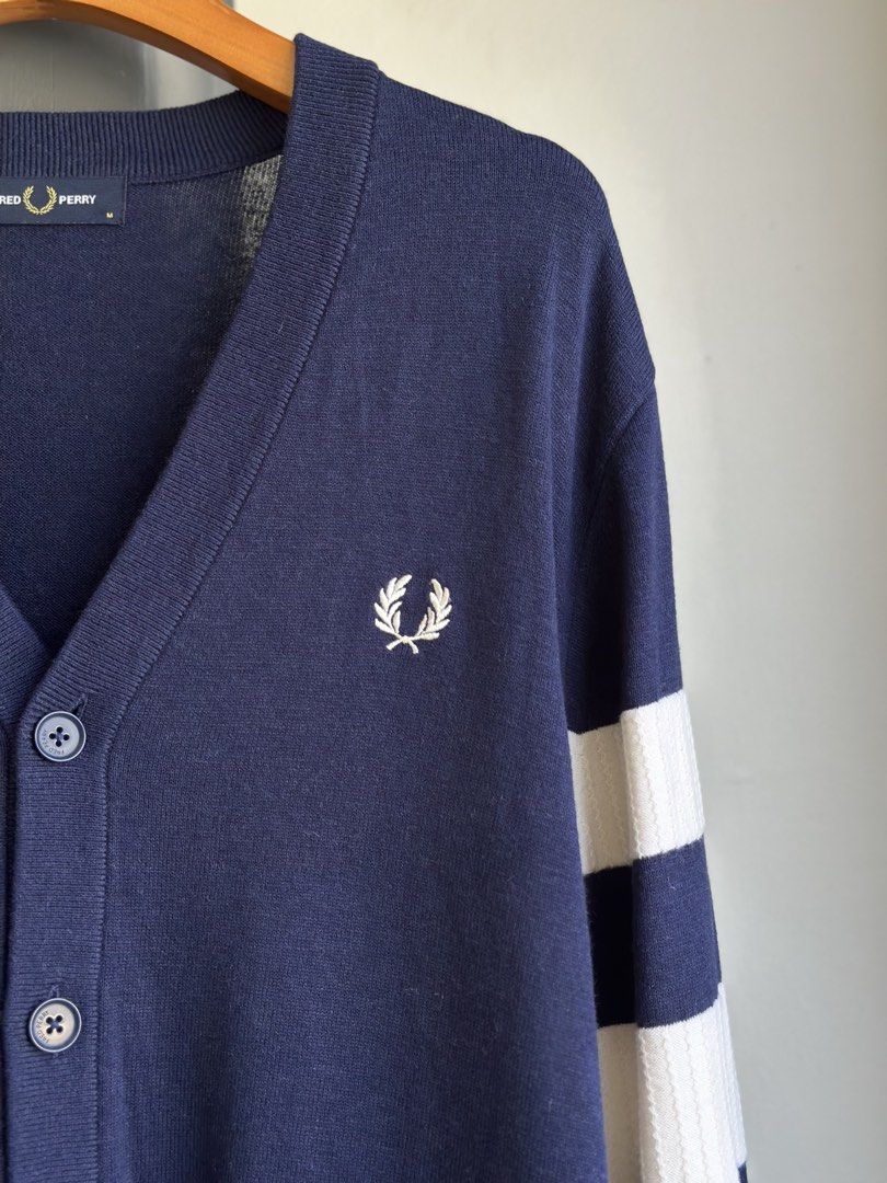 Fred Perry Navy Cardigan with White Stripes (Category: Coats, Jackets and Outerwear) located in Bacolod City. Submitted by thestitchph (Listing ID 1438055298, Image 3). Description: - Fred Perry navy cardigan - Size: M - Features: - White stripes on sleeves - Iconic laurel wreath logo - V-neck - Button closure - Made in China Size medium 21x29” Good as new.
