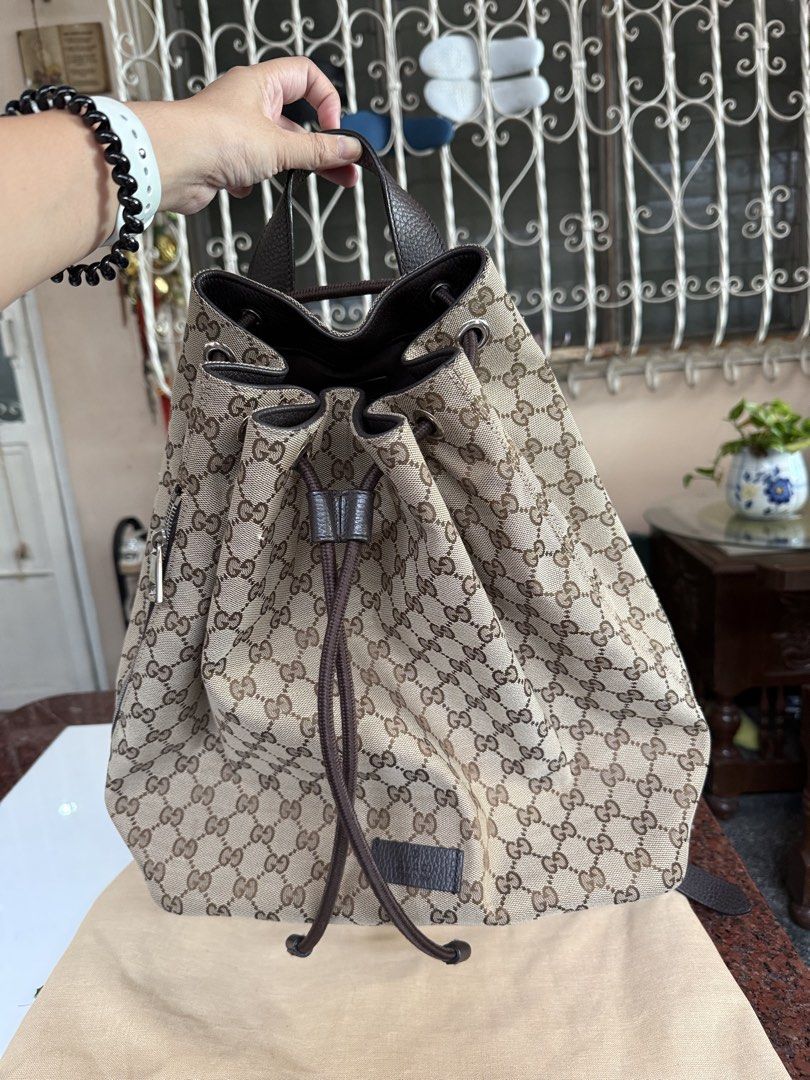 Gucci GG Canvas Drawstring Backpack (Category: Luxury Bags & Wallets) located in Pasig City. Submitted by leldebeer (Listing ID 1437938906, Image 1). Description: - Authentic Gucci backpack - Iconic GG canvas pattern - Drawstring closure - Side zipper for easy access - Adjustable straps - Top handle - Made in Italy - Includes Legitgrails Authentication - Includes Generic dustbag.