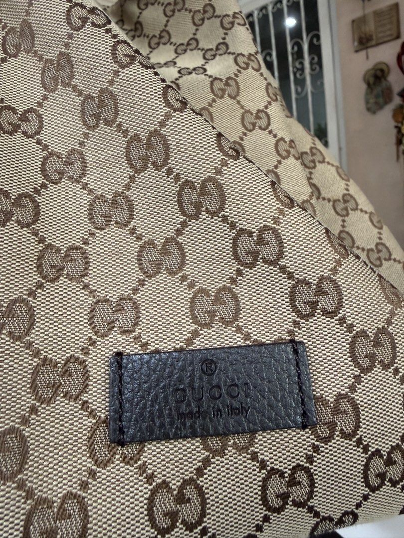Gucci GG Canvas Drawstring Backpack (Category: Luxury Bags & Wallets) located in Pasig City. Submitted by leldebeer (Listing ID 1437938906, Image 3). Description: - Authentic Gucci backpack - Iconic GG canvas pattern - Drawstring closure - Side zipper for easy access - Adjustable straps - Top handle - Made in Italy - Includes Legitgrails Authentication - Includes Generic dustbag.