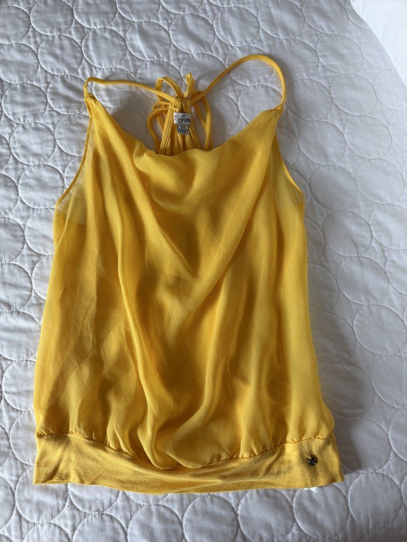 Guess Yellow Cowl Neck Tank Top (Category: Sleeveless) located in Angeles City. Submitted by aicl_ (Listing ID 1437969449, Image 1). Description: - Bright yellow Guess tank top - Halter neck with tie closure - Gathered waist.