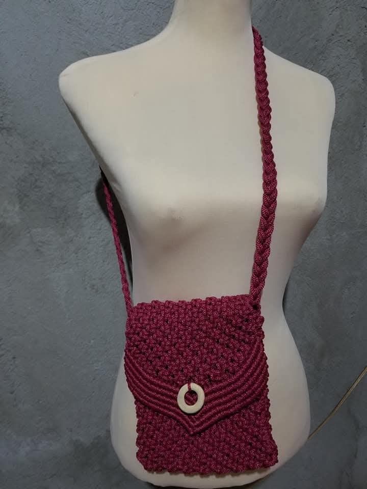 Handmade Macrame Crossbody Bag (Category: Cross-body Bags) located in Bulacan. Submitted by atticus26 (Listing ID 1437998139, Image 2). Description: - Handmade macrame crossbody bag - Woven design with flap closure - Available colors: black with red/yellow/green stripes, maroon, olive green, brown - Braided strap - Perfect for carrying essentials.