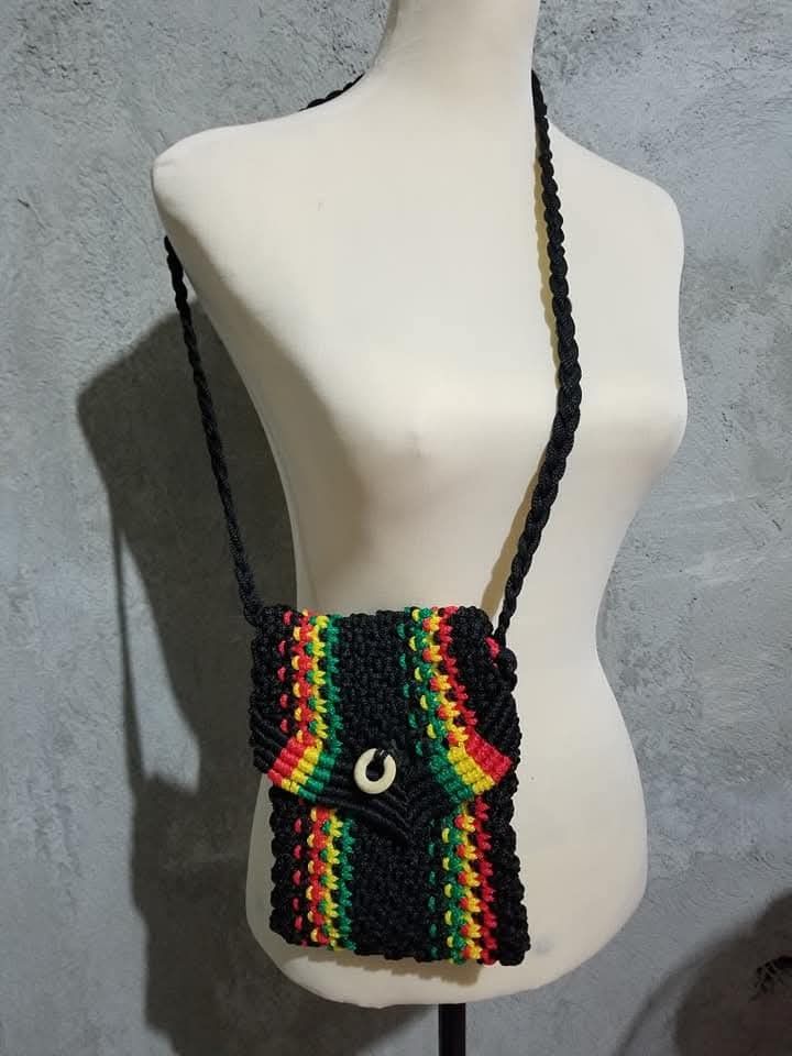 Handmade Macrame Crossbody Bag (Category: Cross-body Bags) located in Bulacan. Submitted by atticus26 (Listing ID 1437998139, Image 1). Description: - Handmade macrame crossbody bag - Woven design with flap closure - Available colors: black with red/yellow/green stripes, maroon, olive green, brown - Braided strap - Perfect for carrying essentials.