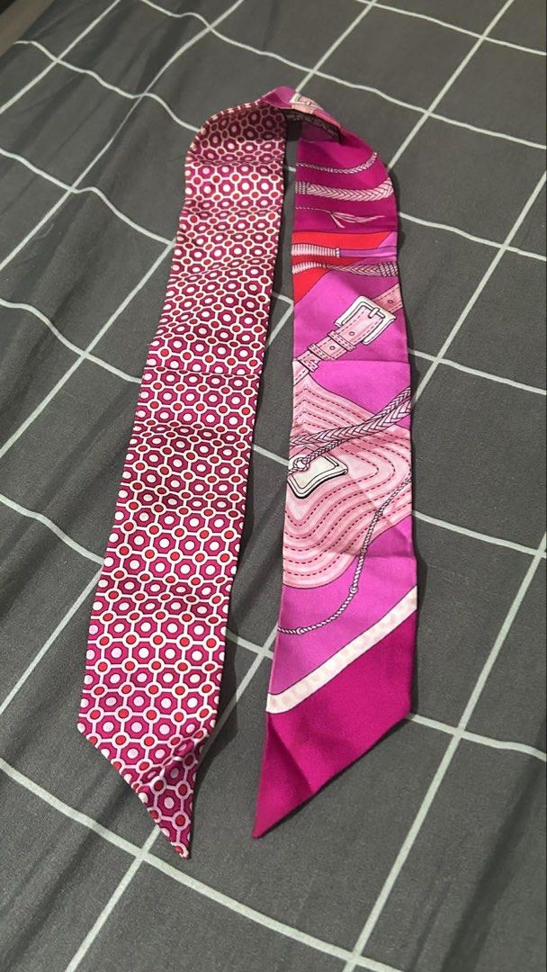Hermès Silk Twilly Scarf (Category: Scarves) located in Taytay. Submitted by stph_declutters (Listing ID 1438068402, Image 1). Description: •Authentic Hermès silk twilly scarf •Vibrant pink and red color scheme •Intricate patterns •100% silk •used once / never been washed ORIGIN: Made in France Color: Fuchsia Size (LxW): 33.85" x 1.96" .