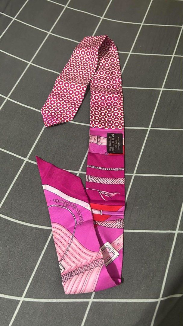 Hermès Silk Twilly Scarf (Category: Scarves) located in Taytay. Submitted by stph_declutters (Listing ID 1438068402, Image 2). Description: •Authentic Hermès silk twilly scarf •Vibrant pink and red color scheme •Intricate patterns •100% silk •used once / never been washed ORIGIN: Made in France Color: Fuchsia Size (LxW): 33.85" x 1.96" .