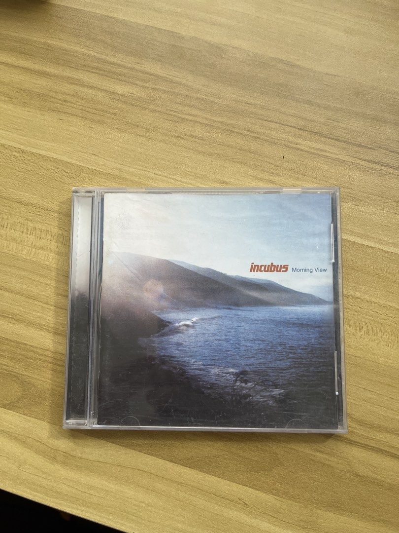 Incubus - Morning View CD (Category: CDs & DVDs) located in Santa Rosa. Submitted by jerano_23 (Listing ID 1437944221, Image 1). Description: - Incubus 'Morning View' CD for sale. - Includes the CD case. - Features the album's original artwork. - Tracklist is printed on the inside cover. - CD has a unique design. - (Note: Second CD partially visible in background is not included.).