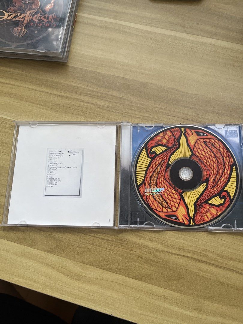 Incubus - Morning View CD (Category: CDs & DVDs) located in Santa Rosa. Submitted by jerano_23 (Listing ID 1437944221, Image 2). Description: - Incubus 'Morning View' CD for sale. - Includes the CD case. - Features the album's original artwork. - Tracklist is printed on the inside cover. - CD has a unique design. - (Note: Second CD partially visible in background is not included.).