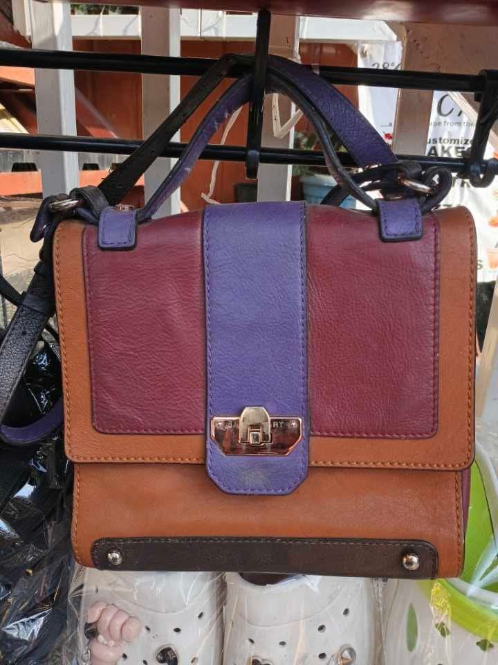 Jill Stuart Color Block Handbag (Category: Luxury Bags & Wallets) located in Baguio. Submitted by castroanna41228 (Listing ID 1437982375, Image 1). Description: - Jill Stuart handbag - Color block design: brown, purple, burgundy - Top handle and detachable shoulder strap - Interior zippered pocket - Gold-tone clasp closure - Jill Stuart branding on clasp.