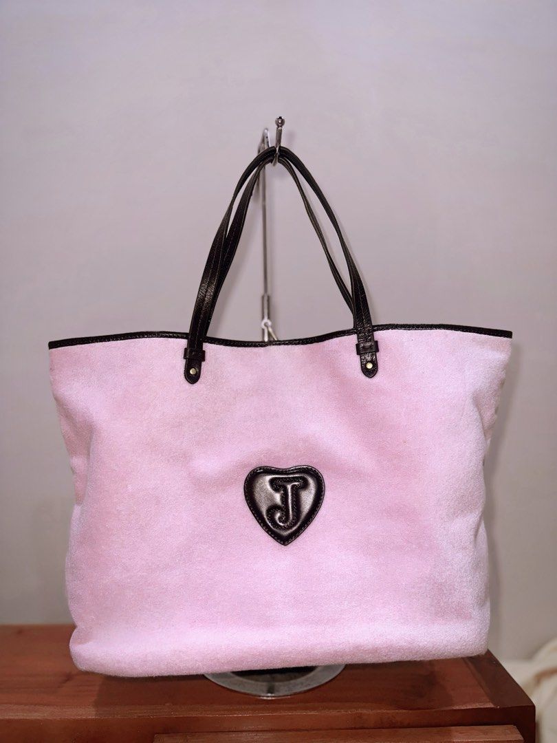 Juicy Couture Pink Tote Bag (Category: Tote Bags) located in Manila. Submitted by pinksavage (Listing ID 1438026658, Image 3). Description: SUPER GANDA! BRAND NEW AS IN. NO PEELING AS WELL. PERFECT 10/10 PRICE NEGO FOR SURE BUYER ONLY! Authentic Juicy Couture tote bag. Pink with brown leather accents. Features logo, key charm, zippered pocket, and patterned lining. Includes heart-shaped patch..