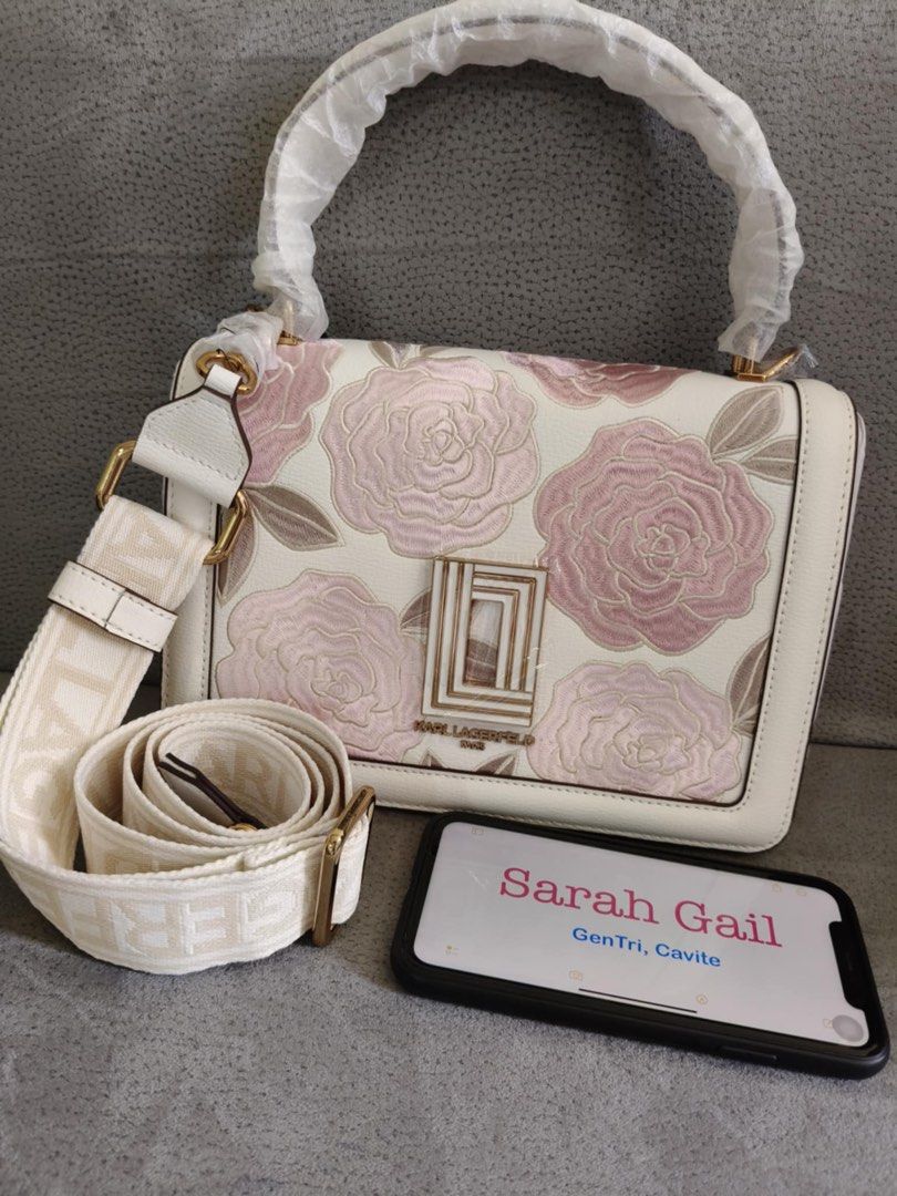 Karl Lagerfeld Floral Shoulder Bag (Category: Shoulder Bags) located in General Trias. Submitted by sarahrd (Listing ID 1438068290, Image 1). Description: - Karl Lagerfeld shoulder bag - Beautiful floral design - White base with pink rose embroidery - Detachable shoulder strap with Karl Lagerfeld logo - Top handle - Gold-tone hardware - Rectangular clasp closure UNUSED . STORED ONLY.