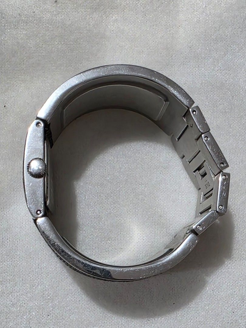 Kenneth Cole New York Watch (Category: Women's Watches) located in Bocaue. Submitted by wendy.plew (Listing ID 1438070602, Image 2). Description: - Kenneth Cole New York watch - Black dial - Silver-tone case - Unique cuff-style design with black textured accents - Rectangular face - Brand name (Kenneth Cole) and 12, 3, 6, 9 hour markers visible - Includes original box and tag -rfs clearance sale /need to let go of mt watches -this is small fit .