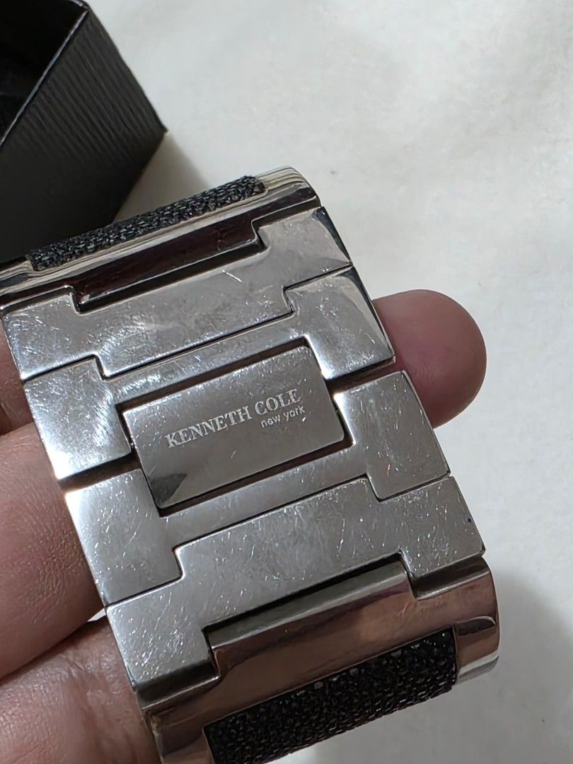 Kenneth Cole New York Watch (Category: Women's Watches) located in Bocaue. Submitted by wendy.plew (Listing ID 1438070602, Image 3). Description: - Kenneth Cole New York watch - Black dial - Silver-tone case - Unique cuff-style design with black textured accents - Rectangular face - Brand name (Kenneth Cole) and 12, 3, 6, 9 hour markers visible - Includes original box and tag -rfs clearance sale /need to let go of mt watches -this is small fit .