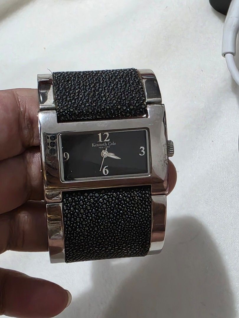Kenneth Cole New York Watch (Category: Women's Watches) located in Bocaue. Submitted by wendy.plew (Listing ID 1438070602, Image 1). Description: - Kenneth Cole New York watch - Black dial - Silver-tone case - Unique cuff-style design with black textured accents - Rectangular face - Brand name (Kenneth Cole) and 12, 3, 6, 9 hour markers visible - Includes original box and tag -rfs clearance sale /need to let go of mt watches -this is small fit .