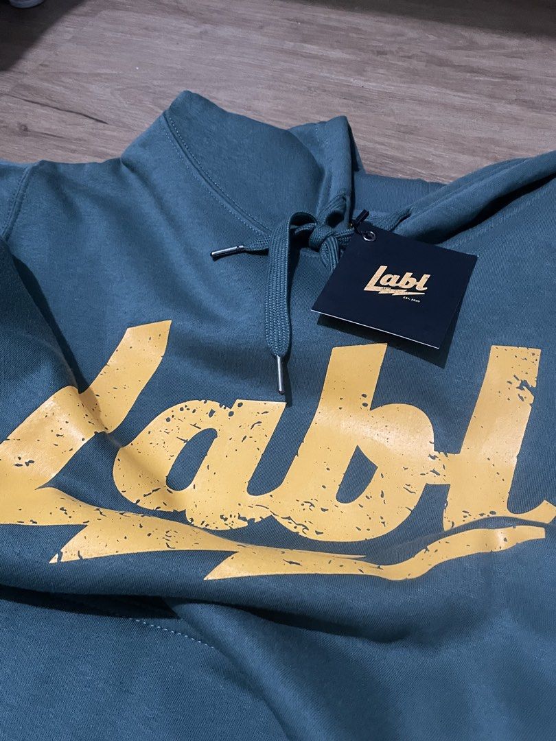 LABL Green Hoodie - Size M (Category: Hoodies) located in Paranaque City. Submitted by uuuuugn1hc.18181818 (Listing ID 1438041792, Image 2). Description: - Green LABL hoodie - Yellow logo - Size: M - Features: Hood with drawstrings, front pocket - Brand logo on lower front and tag - Print: 'Living a Balanced Life'.