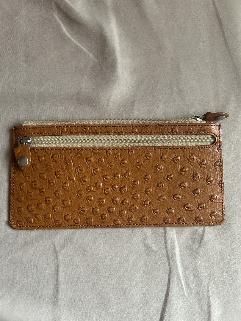 Leather Collection Ostrich Skin Wallet (Category: Wallets & Card holders) located in Quezon City. Submitted by onthehanger_ph (Listing ID 1437954337, Image 1). Description: Genuine ostrich skin leather wallet Features a zipper closure Spacious interior and a slim design Brown exterior, lighter interior .