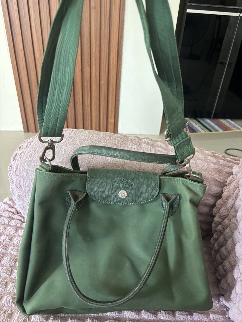 Longchamp Green Handbag with Shoulder Strap (Category: Luxury Bags & Wallets) located in Calauan. Submitted by amaris.boutique.ph (Listing ID 1437968219, Image 2). Description: - Green Longchamp handbag - Top handle and detachable shoulder strap - Flap closure with button - Spacious main compartment - Durable, nylon-like exterior - Silver-tone hardware - Ideal for everyday wear.