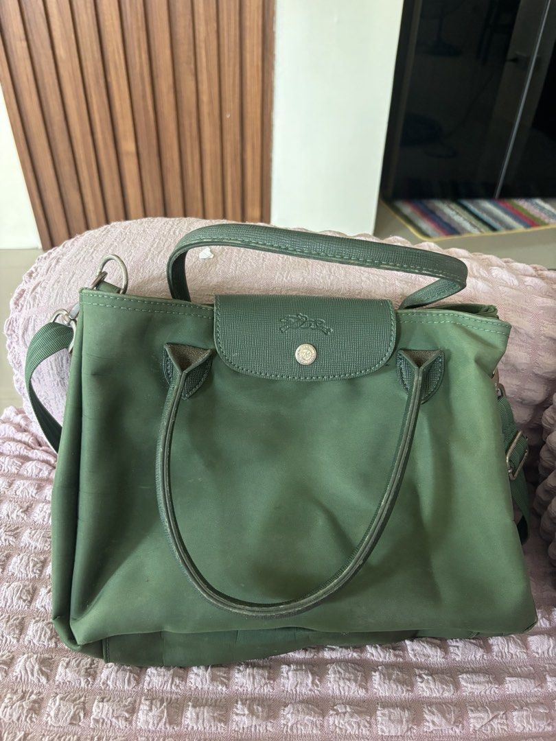 Longchamp Green Handbag with Shoulder Strap (Category: Luxury Bags & Wallets) located in Calauan. Submitted by amaris.boutique.ph (Listing ID 1437968219, Image 1). Description: - Green Longchamp handbag - Top handle and detachable shoulder strap - Flap closure with button - Spacious main compartment - Durable, nylon-like exterior - Silver-tone hardware - Ideal for everyday wear.