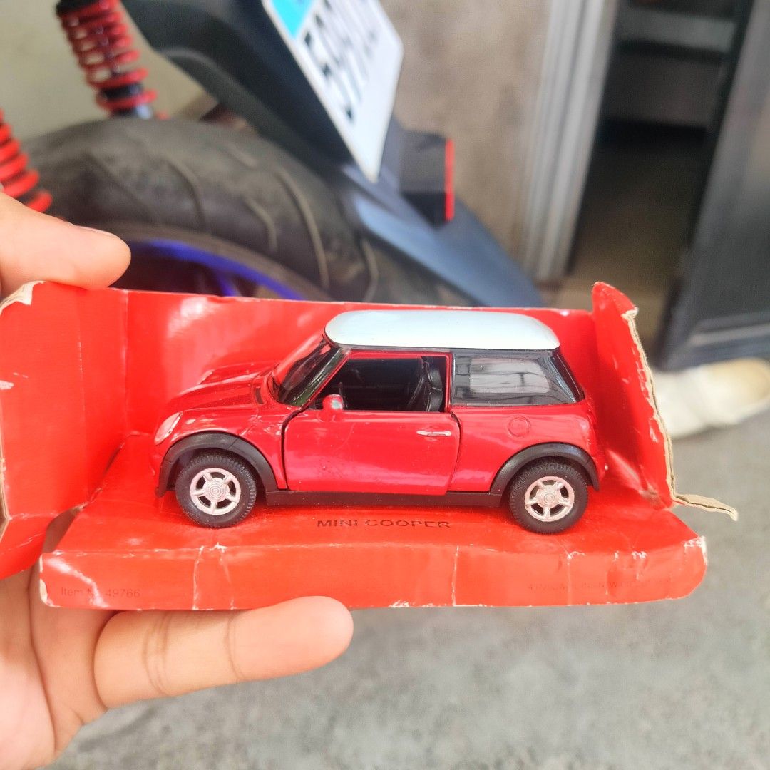 Mini Cooper Toy Car (Category: Vehicle & Diecast Models) located in Plaridel. Submitted by klayskolektibols (Listing ID 1438002930, Image 1). Description: - Red Mini Cooper toy car - White roof - Original packaging - Black wheels with silver rims - Mini Cooper logo on the back - "Cooper" on the license plate.