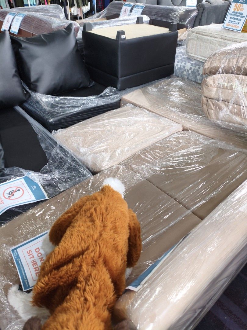 Modular Sofa Set with Pillows (Category: Sofas) located in Manila. Submitted by hmrgrace5. (Listing ID 1437971024, Image 3). Description: - Modular sofa set - Includes black pillows - Features a black square ottoman - Sections are wrapped in plastic - Made of leather or leather-like material - Designed for comfortable seating - Perfect for living rooms or lounges.