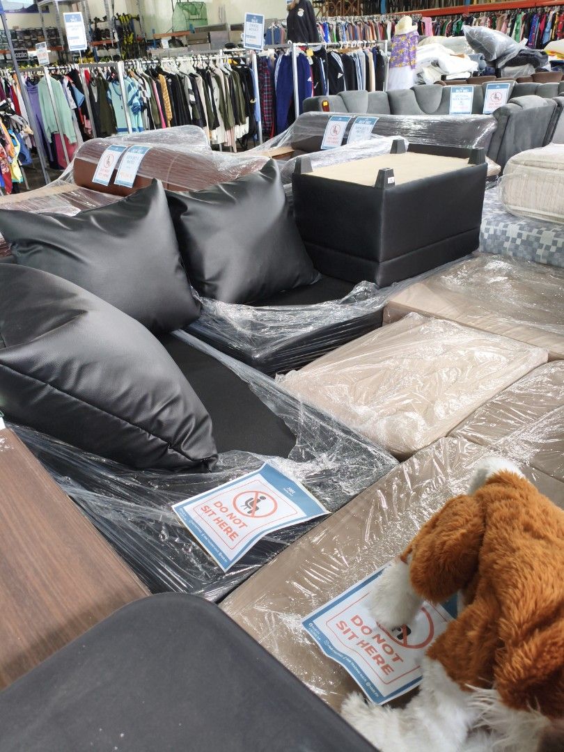Modular Sofa Set with Pillows (Category: Sofas) located in Manila. Submitted by hmrgrace5. (Listing ID 1437971024, Image 2). Description: - Modular sofa set - Includes black pillows - Features a black square ottoman - Sections are wrapped in plastic - Made of leather or leather-like material - Designed for comfortable seating - Perfect for living rooms or lounges.